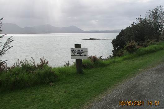 A path leading to a body of water with a sign on it

Description automatically generated with low confidence