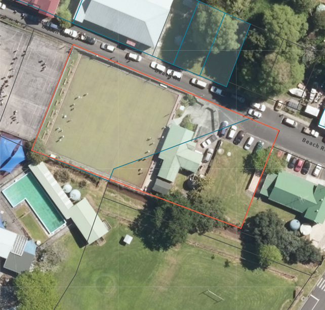 Aerial view of a neighborhood with cars and buildings

Description automatically generated