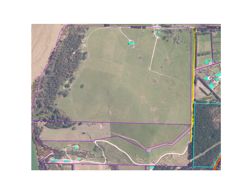 A aerial view of a green field

Description automatically generated